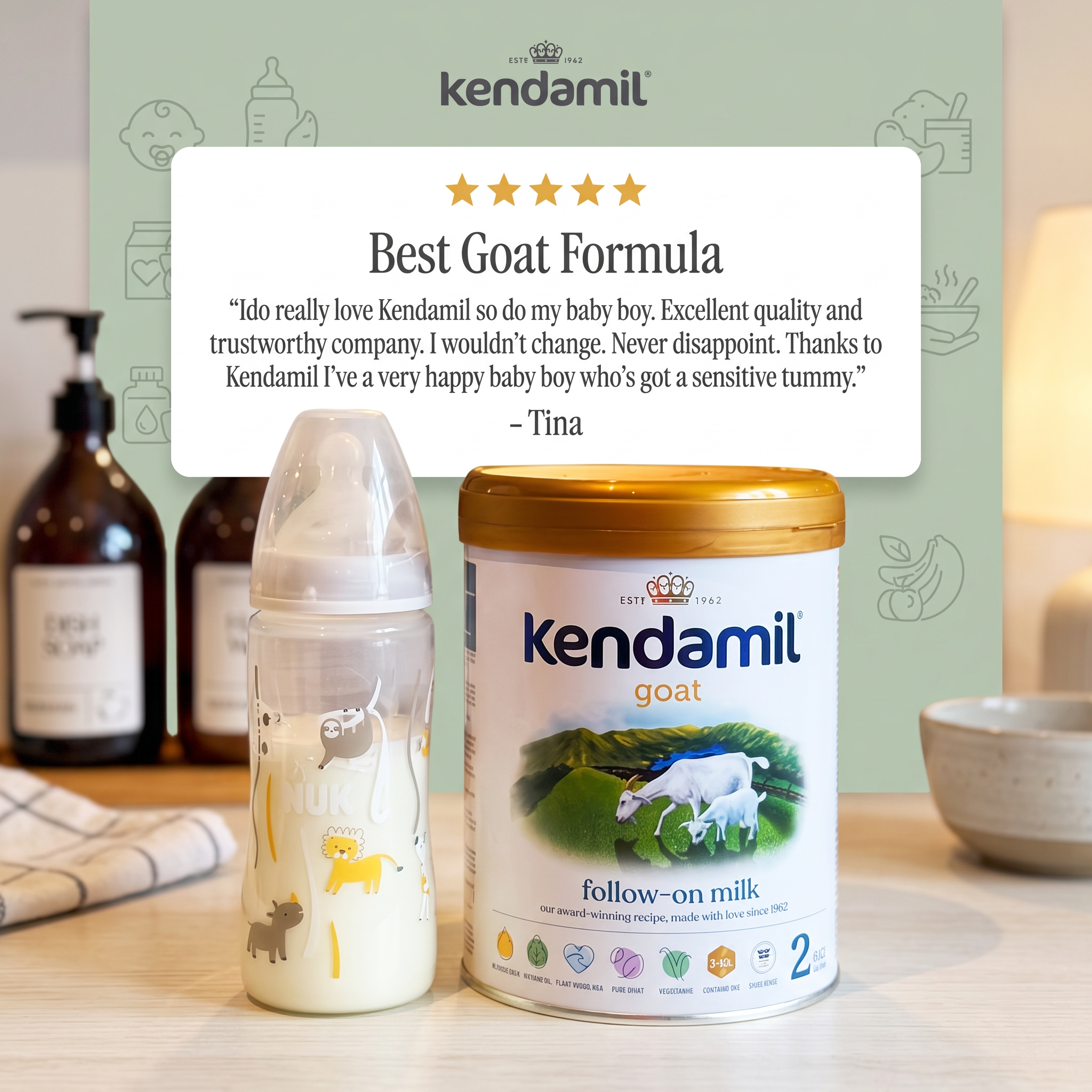 Kendamil goat follow-on milk tin and baby bottle on a kitchen counter below a white card with a five-star review
