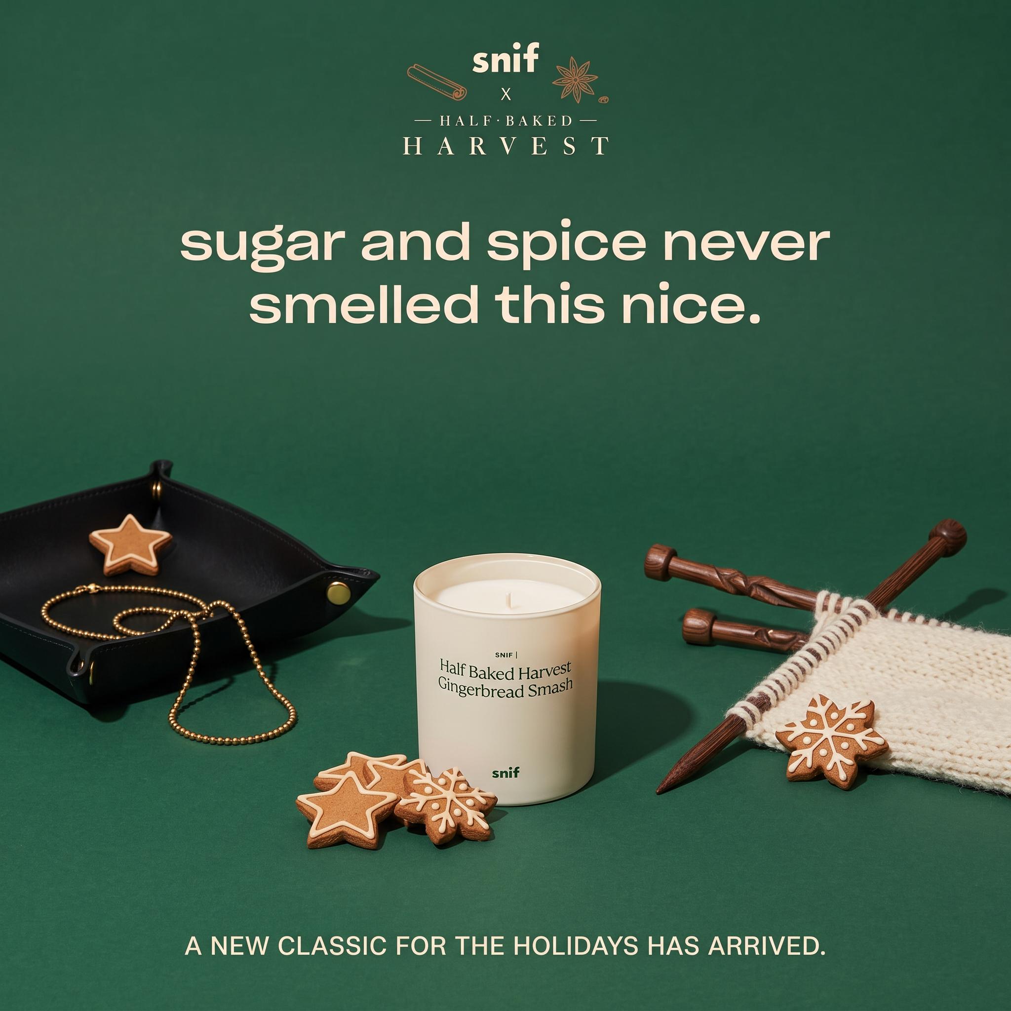 Snif gingerbread candle on deep green with iced cookies, a leather tray with gold chain and knitting needles in cream wool