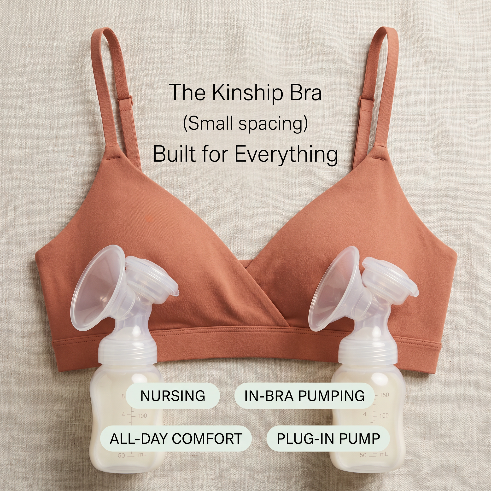 Terracotta nursing bra laid flat on linen with two breast pump bottles and labels for nursing and in-bra pumping