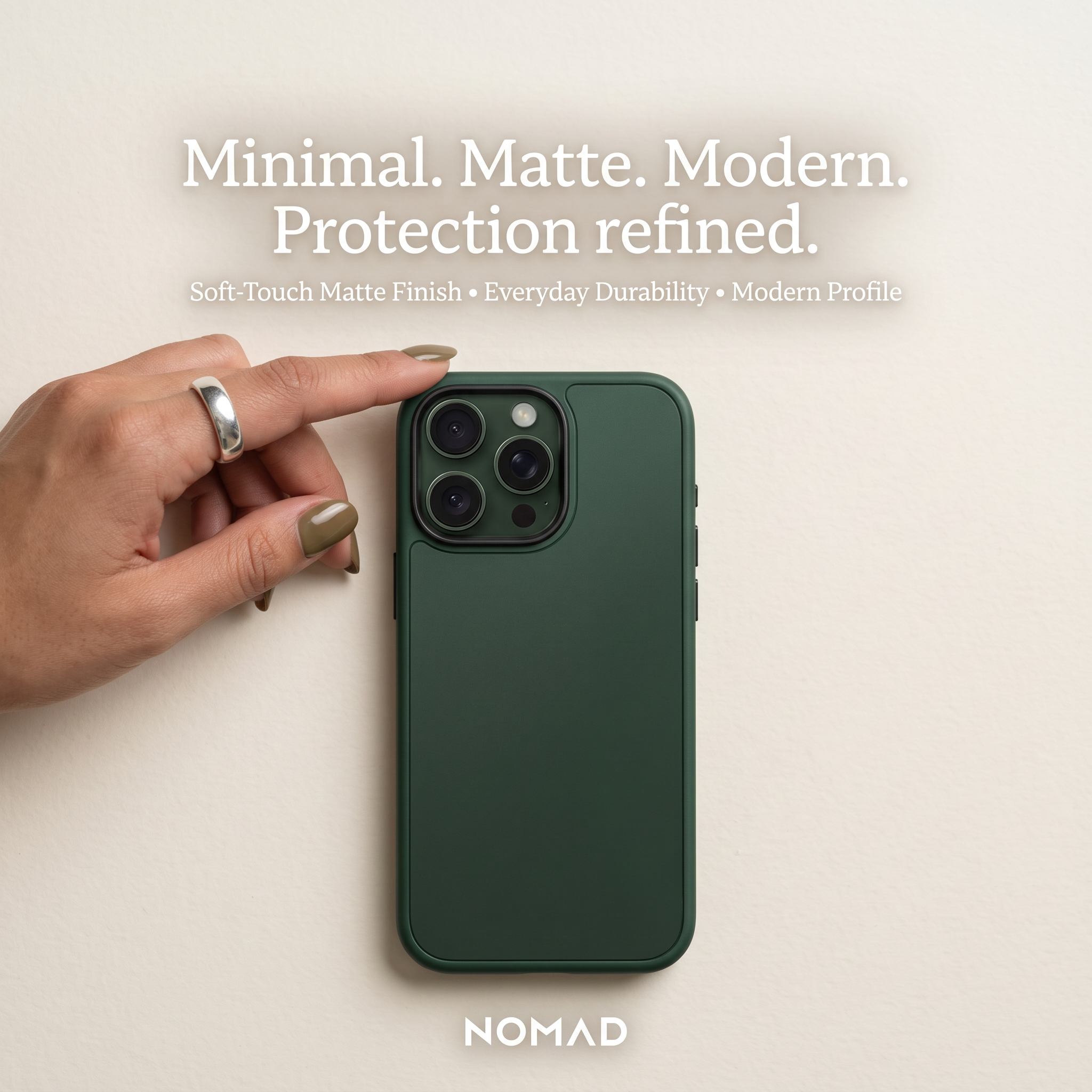 Dark green matte phone case on cream background with a hand touching its edge, headline Minimal. Matte. Modern.