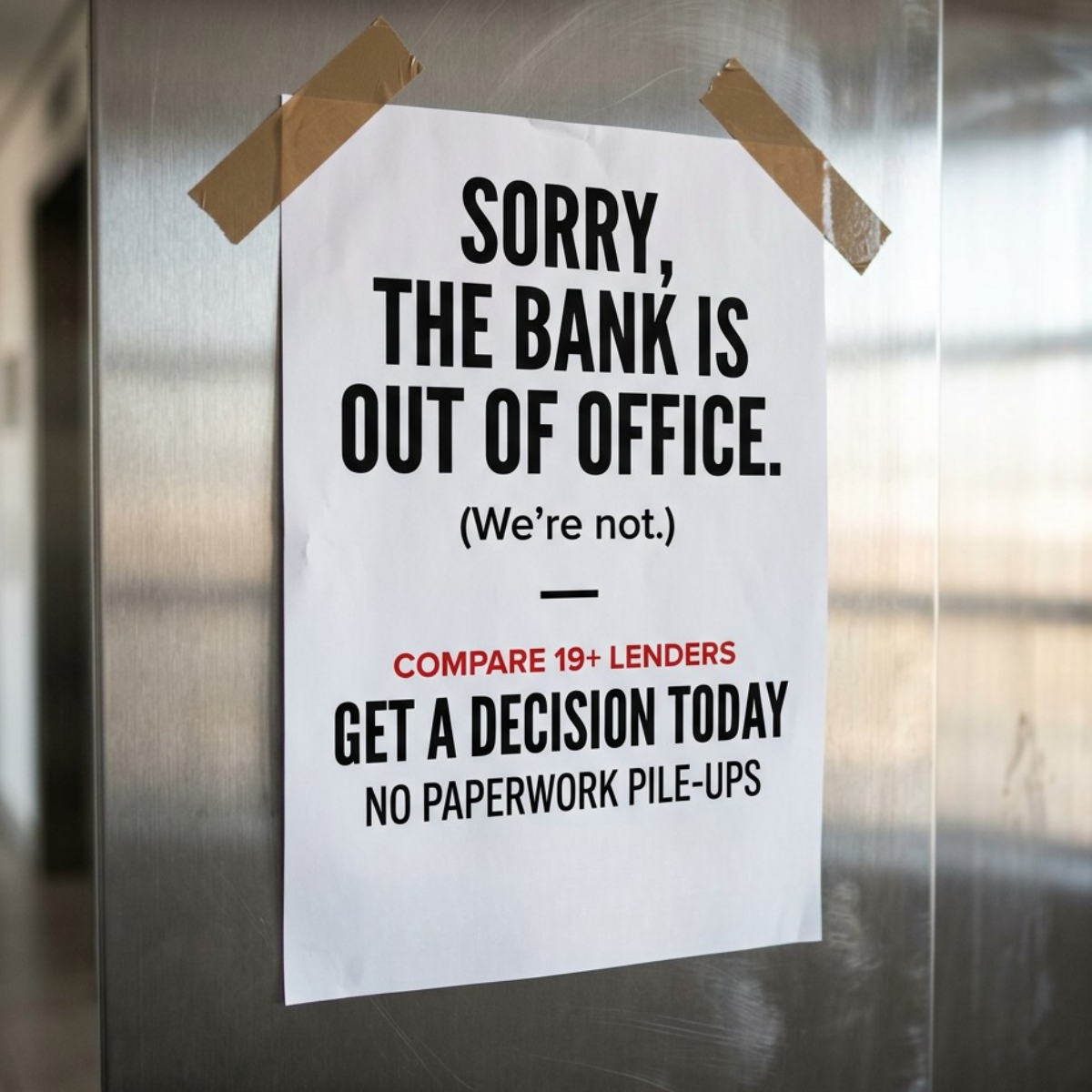 White paper sign taped to a brushed steel door saying 'Sorry, the bank is out of office. (We're not.)' with loan offer text