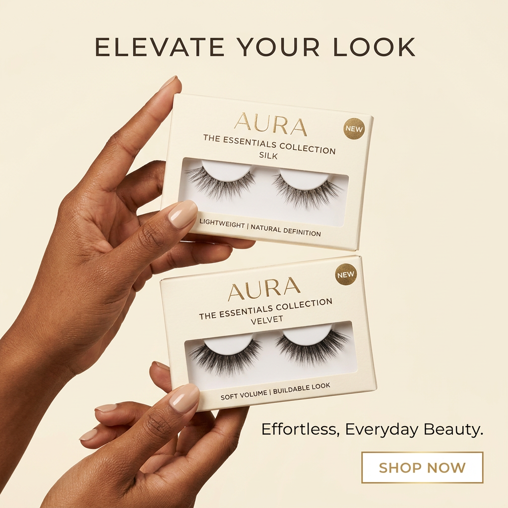 Hands with nude nails hold two AURA false lash boxes, Silk and Velvet, marked New on a cream background