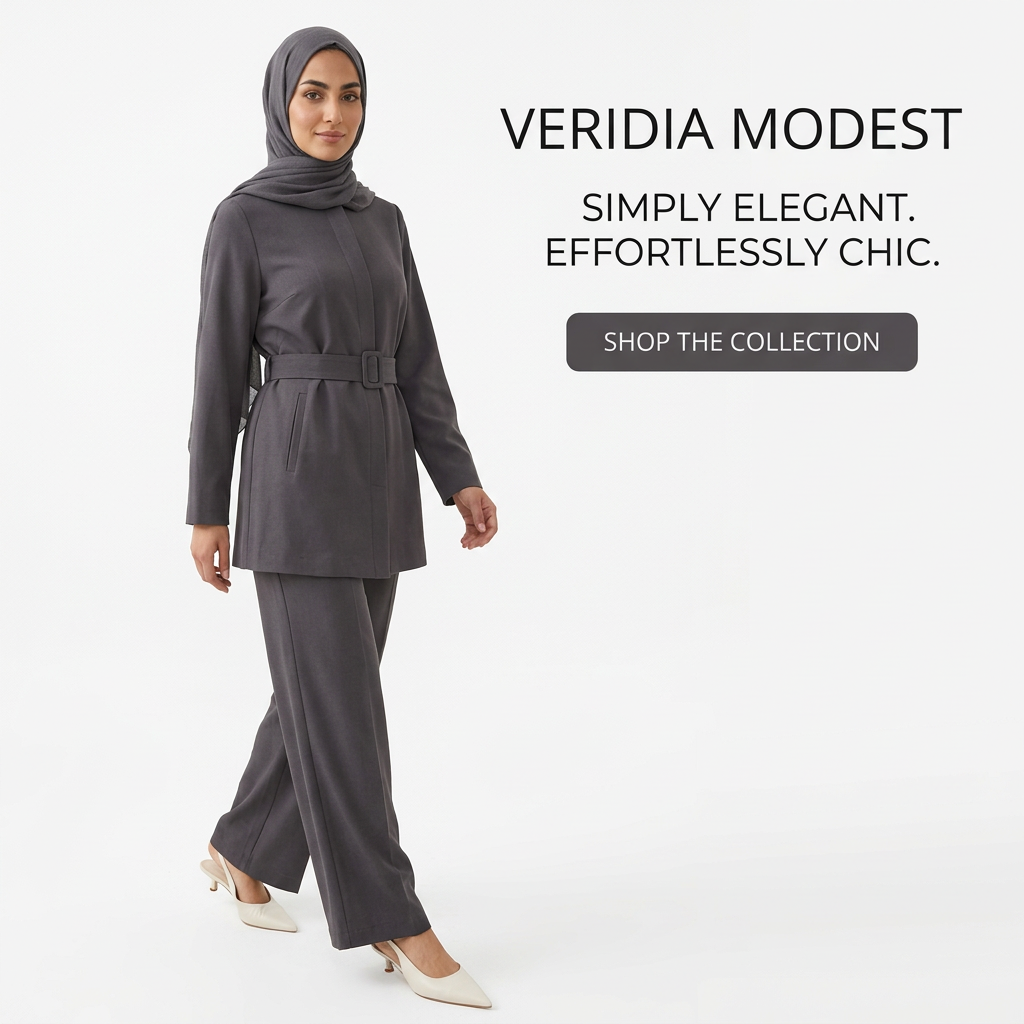 Woman in charcoal hijab, belted tunic and wide-leg trousers walking on a white studio background, Veridia Modest ad