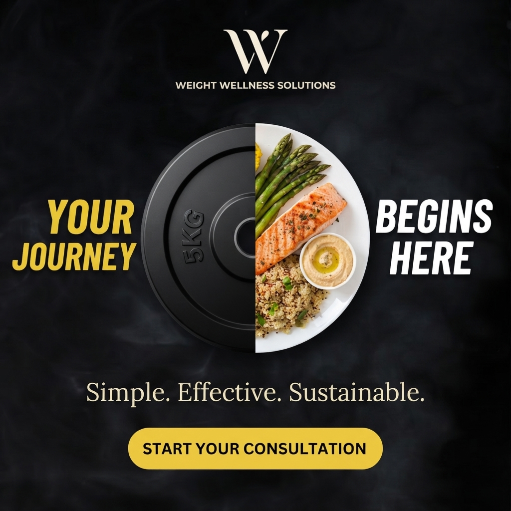 Circle made of half a black 5kg weight plate and half a white plate of salmon, asparagus, quinoa and hummus on black