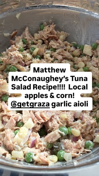 Close-up of tuna salad with peas, corn, apple and red onion in a metal bowl, caption crediting Graza garlic aioli