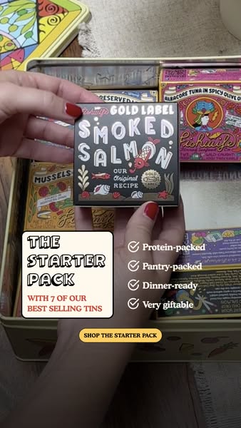 Hand with red nails holding a Gold Label Smoked Salmon tin above an open gift box of Fishwife tins, with checklist text