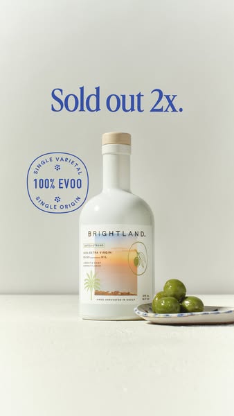 White Brightland Castelvetrano olive oil bottle next to a plate of green olives with Sold out 2x headline and EVOO badge
