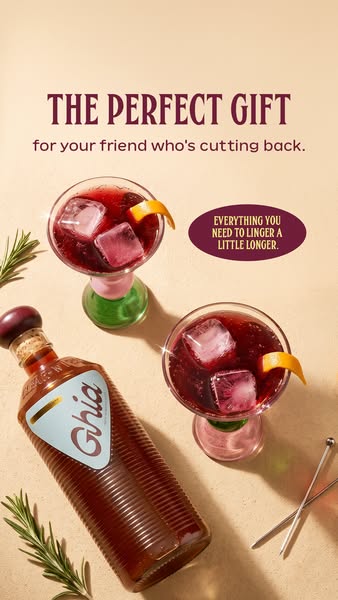 Ghia apéritif bottle on peach surface beside two iced cocktails with orange twists and rosemary, The Perfect Gift headline