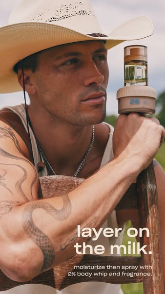 Man in cowboy hat with snake tattoo holding Snif 2% fragrance stacked on 2% body whip jar outdoors, text layer on the milk