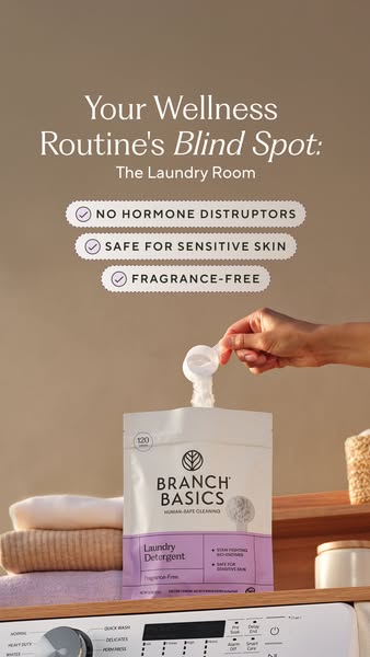 Hand scooping from a Branch Basics laundry pouch on a washer, headline Your Wellness Routine's Blind Spot