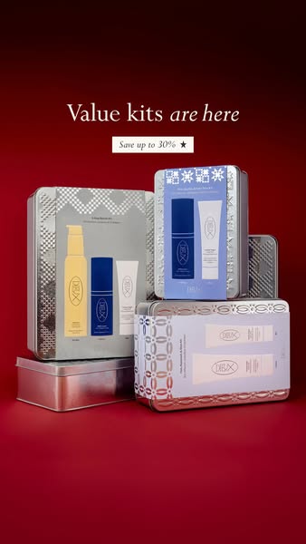 Stack of silver patterned Dieux skincare gift tins on deep red background with headline Value kits are here