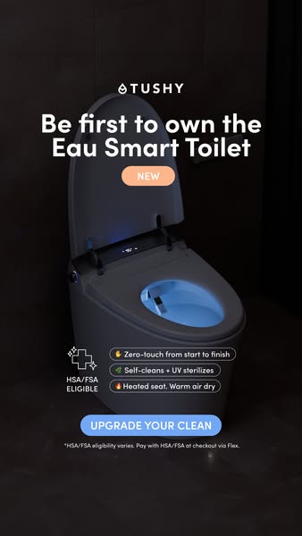 Glowing TUSHY Eau smart toilet in a dark room with NEW badge, three feature pills and Upgrade Your Clean button