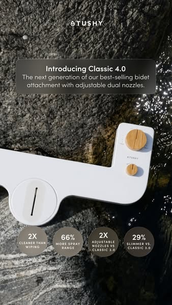 White TUSHY Classic 4.0 bidet attachment with bamboo knobs on wet dark rock with four stat circles