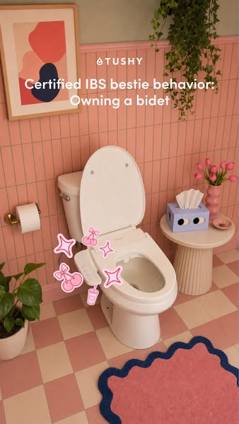 Pink tiled bathroom with a TUSHY bidet seat, cherry and sparkle stickers, tulips, checkered floor and wavy rug