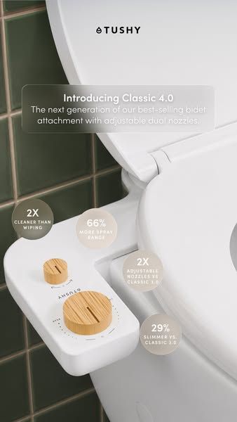 TUSHY Classic 4.0 bidet attachment with bamboo knobs installed on a white toilet, green tiles and four stat bubbles