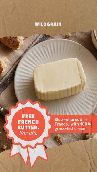 Block of slow-churned butter on a ridged white plate with a coral 'Free French butter. For life.' rosette badge