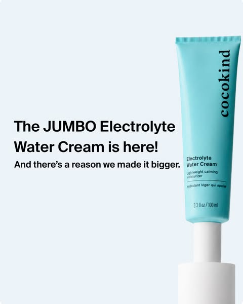 Teal Cocokind Electrolyte Water Cream tube on a white stand against pale blue, with a jumbo launch headline