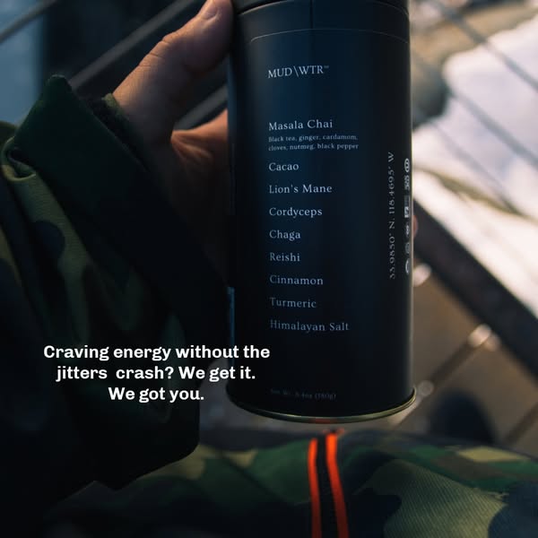 Hand in a camo jacket holding a MUD WTR tin outdoors on stairs with text about energy without the jitters crash