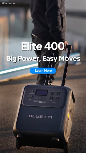 Person pulling the Bluetti Elite 400 power station on wheels by its telescopic handle along a waterfront at dusk