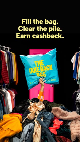 Hand holding a blue Take Back Bag up out of a huge pile of clothes in front of a pink door, text Fill the bag. Clear the pile. Earn cashback.