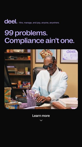 Snoop Dogg in sunglasses and a white jacket typing at an office desk, with Deel headline 99 problems. Compliance ain't one.