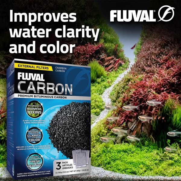 Fluval Carbon box with headline Improves water clarity and color, in front of a clear planted aquarium with small fish