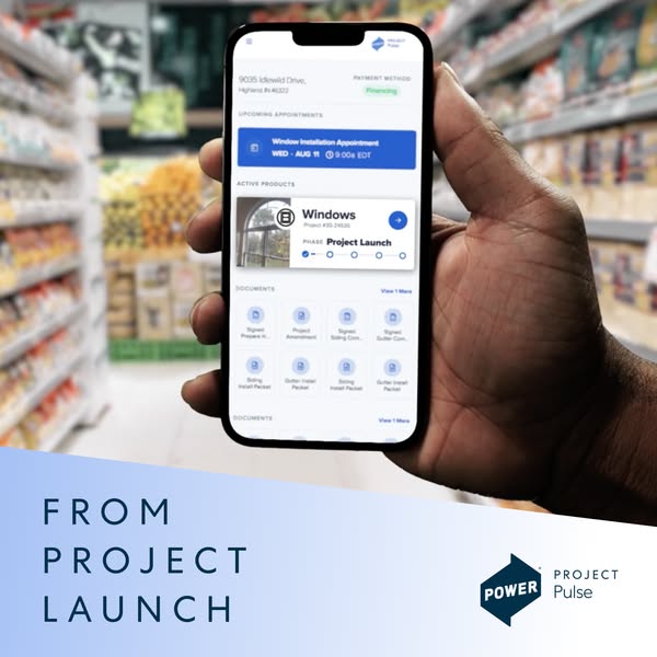 Hand holding a phone in a grocery aisle showing the Project Pulse app with a windows project in the Project Launch phase