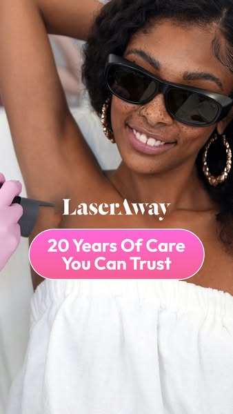 Smiling woman in protective glasses receiving underarm laser hair removal with LaserAway 20 years trust message