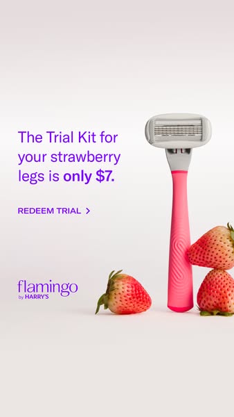 Pink Flamingo razor standing upright beside three fresh strawberries, text offering the Trial Kit for $7