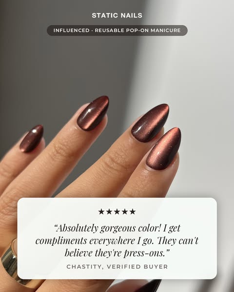 Close-up of almond press-on nails in deep cherry-brown chrome with a white five-star customer review card overlaid