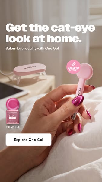 Dashing Diva One Gel ad showing a hand with magenta cat-eye nails holding the pink magnet wand above white bedsheets...