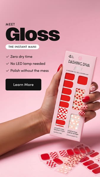 Dashing Diva Gloss ad showing a hand with red, checkerboard and strawberry accent nails holding the pink Gloss pack, with...