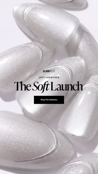 Close-up of shimmering pearly white press-on nails filling the frame with The Soft Launch text and black button