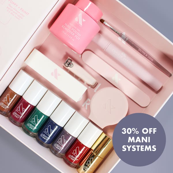 Open Olive & June mani system box with seven quick dry nail polishes and tools, with a round 30% off badge