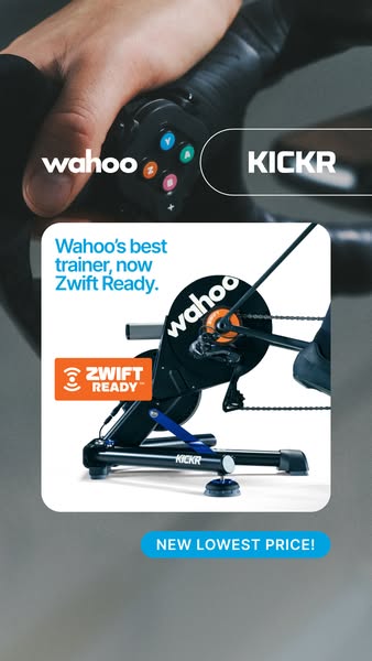 Wahoo KICKR smart trainer in a white card with Zwift Ready badge and New Lowest Price label over a blurred photo