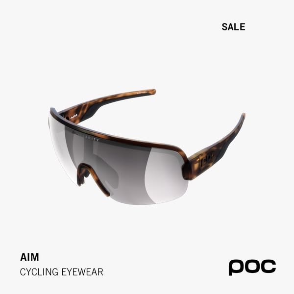 POC AIM cycling sunglasses with tortoiseshell frame and grey shield lens on a light grey background with SALE tag