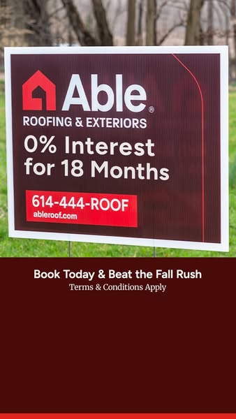 Able Roofing yard sign on a lawn advertising 0% interest for 18 months and phone number 614-444-ROOF