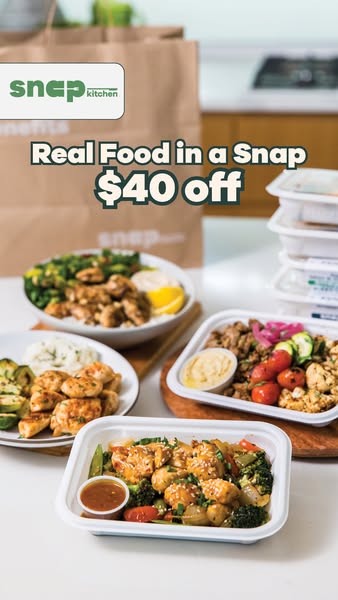 Snap Kitchen meals and branded bags on a kitchen counter with text Real Food in a Snap $40 off