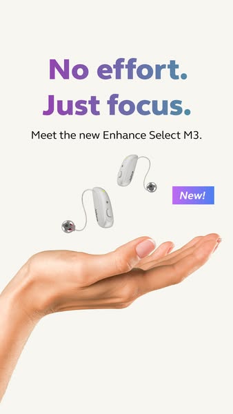Two small white Jabra hearing aids floating above an open palm under the purple gradient headline No effort. Just focus.