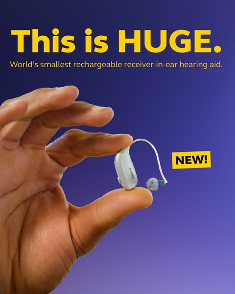A hand pinching a tiny white Jabra hearing aid between two fingers on a purple background under the yellow headline This is HUGE.