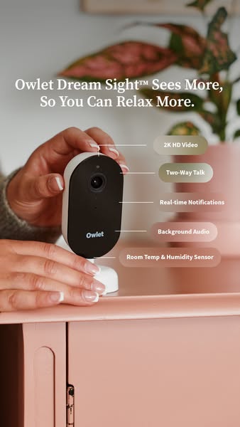 Hands place an Owlet Dream Sight camera on a coral dresser with labels for 2K video, talk, alerts, audio and room sensor