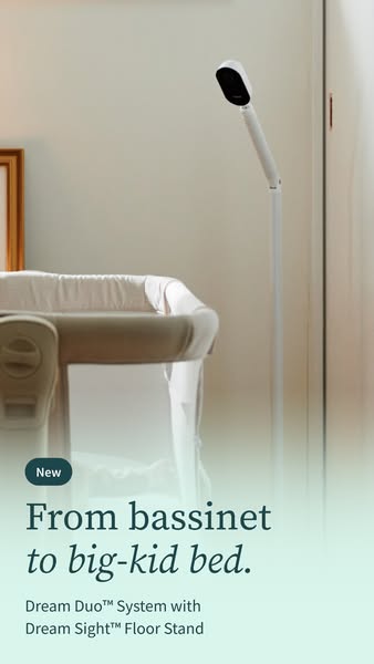 White Owlet camera on a tall floor stand next to a bassinet in a bright room, with a mint gradient and headline below