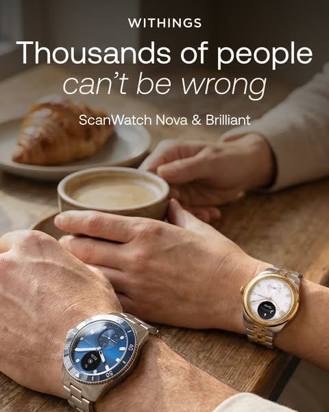 Two people at a café table wearing Withings ScanWatch Nova blue diver and ScanWatch Brilliant gold watches, with coffee.