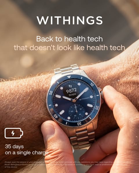 Hand adjusting a Withings ScanWatch Nova blue dive watch showing 9872 steps in golden-hour light, 35-day battery icon.