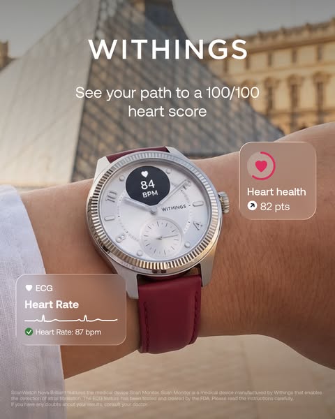 Withings ScanWatch Nova Brilliant with red leather strap in front of the Louvre pyramid, heart health 82 pts and ECG cards.