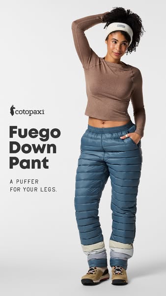 Smiling woman in slate blue Cotopaxi Fuego down pants, brown top and white headband on a light grey background