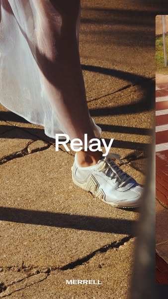 White Merrell Relay sneaker with metallic side detail on a sunlit cracked pavement next to the hem of a sheer white dress