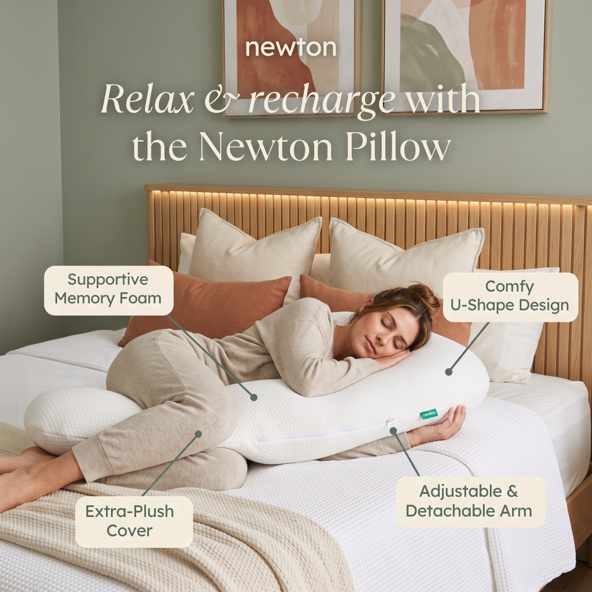 Woman sleeping on a white U-shaped Newton body pillow in a sage green bedroom with four feature labels around her
