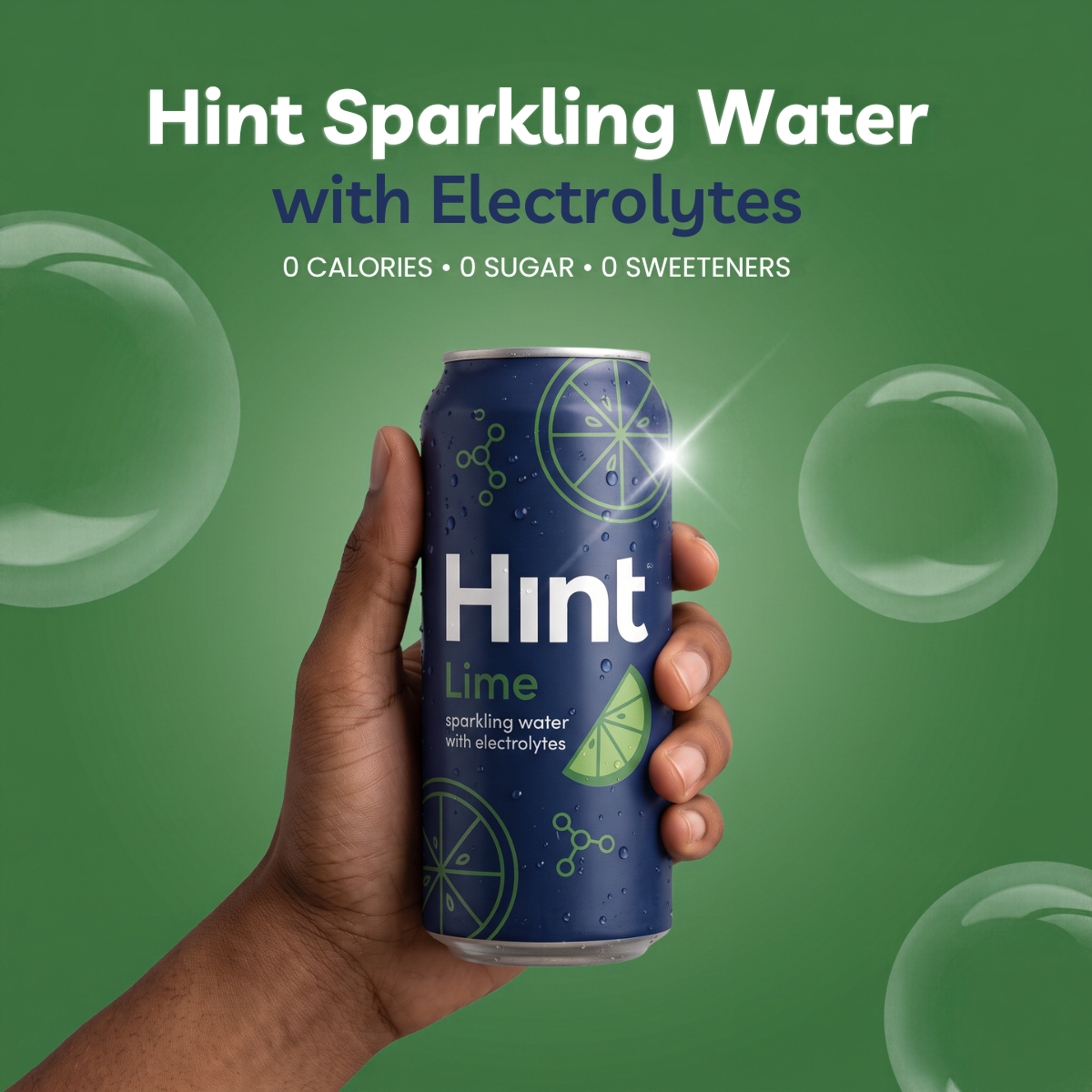 Hand holding a navy Hint Lime sparkling water can on a green background with bubbles and a zero calories headline